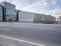 street in front of the building with an empty sign on it near an empty road