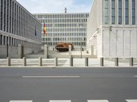 a couple of buildings sit empty in the foreground and a horse stands out behind it