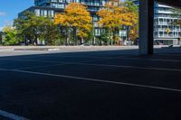 the car park area is empty of cars and a bus waiting for passengers to go