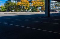 the car park area is empty of cars and a bus waiting for passengers to go