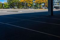 the car park area is empty of cars and a bus waiting for passengers to go