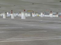 an empty car parking lot with no cars on it's sides and signs in red
