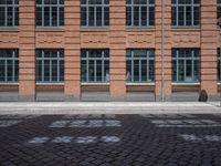 brick streets are filled with empty seats and chairs in the middle of them, a fire hydrant is visible