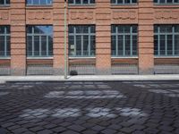 brick streets are filled with empty seats and chairs in the middle of them, a fire hydrant is visible
