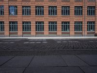 brick streets are filled with empty seats and chairs in the middle of them, a fire hydrant is visible