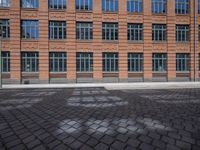 brick streets are filled with empty seats and chairs in the middle of them, a fire hydrant is visible