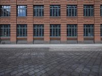 brick streets are filled with empty seats and chairs in the middle of them, a fire hydrant is visible