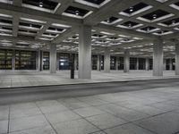 an empty city area with lots of empty floors and rows of large buildings in the background