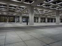 an empty city area with lots of empty floors and rows of large buildings in the background