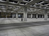 an empty city area with lots of empty floors and rows of large buildings in the background