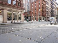 this is an image of a city corner, which looks to be empty and has trash bags scattered on the street
