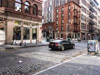 this is an image of a city corner, which looks to be empty and has trash bags scattered on the street