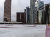 a city is empty, and the sky looks grey with clouds above it and there are three large buildings in the background