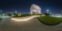 the view of an empty city park from an artisticly decorated ramp with illuminated lines