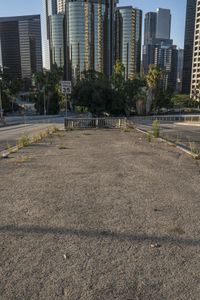 the parking lot at an empty city has many weeds on it, including the street signs