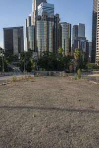 the parking lot at an empty city has many weeds on it, including the street signs