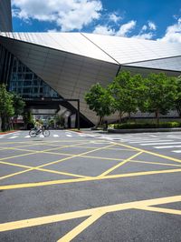 yellow lines in an empty city road near glass buildings on the horizon in the daytime