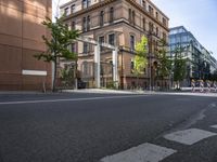 there is an empty city street with a road closed to traffic and buildings in the back