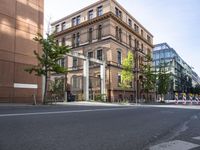 there is an empty city street with a road closed to traffic and buildings in the back