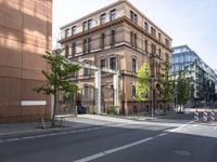 there is an empty city street with a road closed to traffic and buildings in the back