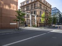 there is an empty city street with a road closed to traffic and buildings in the back