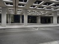 empty city street in concrete building structure with white ceiling tiles on roof area and people walking