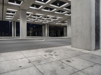 empty city street in concrete building structure with white ceiling tiles on roof area and people walking