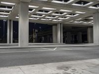 empty city street in concrete building structure with white ceiling tiles on roof area and people walking