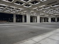 empty city street in concrete building structure with white ceiling tiles on roof area and people walking