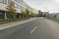 the empty city street is empty with no traffic on it, so no people are crossing the streets