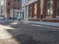 a very big empty city street with a red and white fire hydrant near the curb