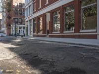 a very big empty city street with a red and white fire hydrant near the curb