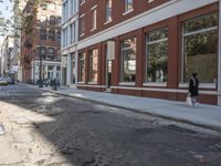 a very big empty city street with a red and white fire hydrant near the curb