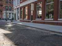 a very big empty city street with a red and white fire hydrant near the curb