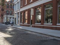 a very big empty city street with a red and white fire hydrant near the curb