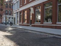 a very big empty city street with a red and white fire hydrant near the curb