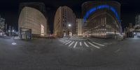 a fisheye lens looking at an empty city street in the evening, and its circular shaped building