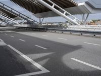 the empty city street is empty and ready to be used for traffic purposes, including the bridge