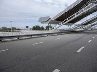 the empty city street is empty and ready to be used for traffic purposes, including the bridge