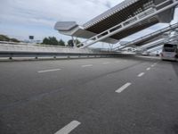 the empty city street is empty and ready to be used for traffic purposes, including the bridge