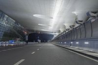 an empty street inside a modern building with skylights over it, and no people in the image