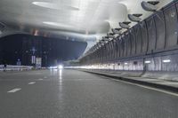an empty street inside a modern building with skylights over it, and no people in the image