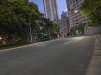 empty street in front of buildings on a city block during night time with blue sky