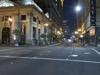 an empty city street at night with no traffic cones on it, with lights on