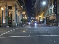 an empty city street at night with no traffic cones on it, with lights on