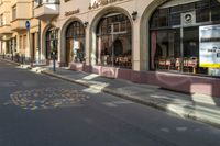 an empty city street is painted with dots in the road as well as buildings and people