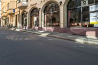 an empty city street is painted with dots in the road as well as buildings and people