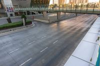 the view of an empty street on a city street at sunrise from an observation platform