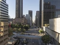 an empty city street, with taxis and cars on it and people on either side of the road