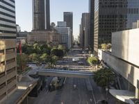 an empty city street, with taxis and cars on it and people on either side of the road